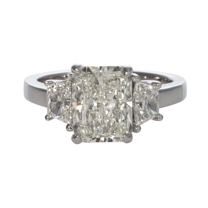 Shine Bright With Our Special Jewelry Promotions 3ct Radiant & .71ct Trapezoid Side Diamond Three-Stone Platinum Ring